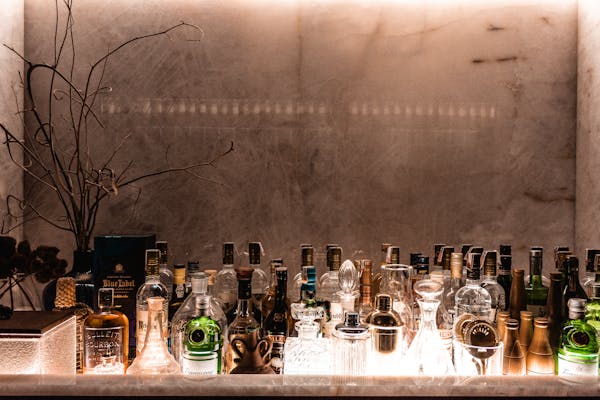 liquor shelf with many bottles lined up