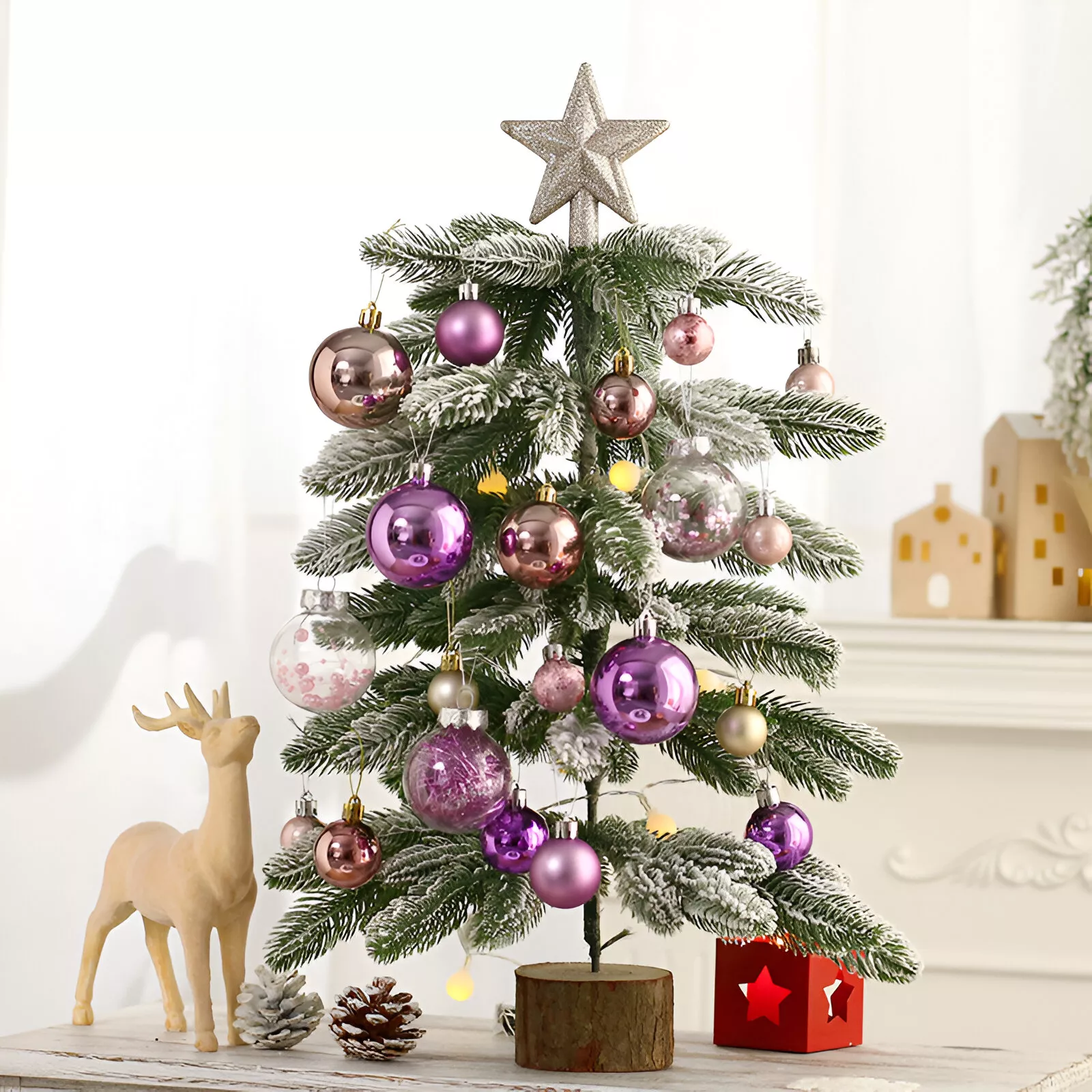 Desktop christmas tree decorated with gold and purple baubles